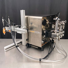 Load image into Gallery viewer, Rear side view of the tabletop FG-200 bottle filling machine with push-to-connect hoses and EZ Adjust Nozzle Arm in a stainless steel table