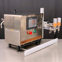 Load image into Gallery viewer, Front side of the FG-200 bottle filling machine with two N100-S stainless nozzles on a stainless steel table
